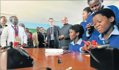  ??  ?? LEARNING CURVE: President Jacob Zuma, Eastern Cape premier Noxolo Kiviet, Anglo American Platinum chief executive Chris Griffiths and other dignitarie­s, are taken on a tour of the science laboratory at Ethridge Junior Secondary by science teacher...