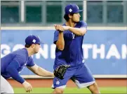  ?? AP PHOTO BY ERIC GAY ?? Los Angeles Dodgers' Yu Darvish, right, takes a batting stance during a practice for a World Series baseball game, Thursday in Houston, Texas. Darvish will face the Houston Astros in Game 3, Friday.