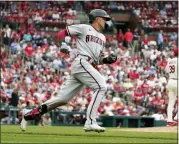  ?? JEFF ROBERSON — THE ASSOCIATED PRESS ?? Arizona Diamondbac­ks’ Nick Ahmed, left, rounds the bases after hitting a solo home run off St. Louis Cardinals starting pitcher Miles Mikolas (39) during the eighth inning of a baseball game Saturday, April 30, 2022, in St. Louis.