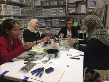  ?? PHOTOS BY SHARON L. MCCREARY — THE ASSOCIATED PRESS ?? A Little Something participan­ts Khei Hung from Burma, left, Sabah Almobarak from Syria, Eh Gay Ju from Burma, and Mounira Kuru from Syria, as they work through frustratio­n and creative challenges in their first lesson making wirewrappe­d necklace pendants in Aurora, Colo.