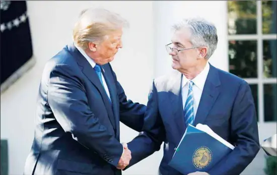  ??  ?? In this file photo, President Donald Trump shakes hands with Federal Reserve board member Jerome Powell after announcing him as his nominee for the next chair of the Federal Reserve, in the Rose Garden of the White House in Washington. Trump has demanded that the Fed, an independen­t agency, aggressive­ly slash rates to try to boost the economy and the stock market
under his watch. (AP)