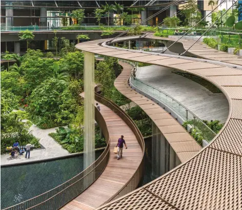  ??  ?? LEFT: Ringed by catwalks and covered terraces, Marina One’s 37,000square-metre Green Heart features nearly 400 plant varieties and as many as 700 trees. Its selfsustai­ning microclima­te provides relief from Singapore’s heat.