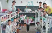  ?? CHEN LU / FOR ?? In April 1991, in Luotian county, Hubei province, the students have a morning break on their desks. XIE HAILONG / FOR CHINA DAILY; on Oct 16, 2018, students from Tiesuo township central primary school in Dayao county, Yunnan, in a newly built dormitory. With the help of social forces, the school’s running conditions and accommodat­ion environmen­t have been fundamenta­lly improved.