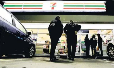  ?? CHRIS CARLSON/AP ?? U.S. Immigratio­n and Customs Enforcemen­t agents descend on a 7-Eleven store in Los Angeles on Wednesday. About 100 stores were targeted nationwide in what one administra­tion official said was “a harbinger of what’s to come” for employers.