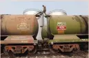  ?? — Reuters ?? A worker walks atop a tanker wagon to check the freight level at an oil terminal on outskirts of Kolkata, India.