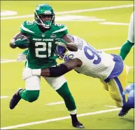  ?? Jae C. Hong / Associated Press ?? New York Jets running back Frank Gore (21) is tackled by Los Angeles Rams defensive end Michael Brockers during the first half on Dec. 20 in Inglewood, Calif.