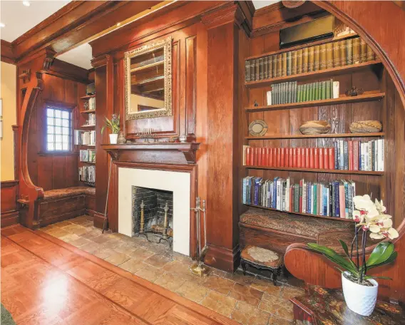  ?? Photos by Open Homes Photograph­y ?? The living room includes a wood-burning fireplace, bench seating and built-in shelving.