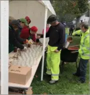  ?? TAWANA ROBERTS — THE NEWS-HERALD ?? Volunteers fill jars with fresh apple butter on Oct. 13 for the annual Apple Butter Festival at the Century Village Museum in Burton Village. The two-day event continues today.