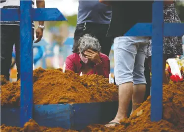  ?? BRUNO KELLY/ REUTERS ?? A woman is despondent during a mass burial of people who passed away due to COVID-19 at the Parque Taruma cemetery in Manaus, Brazil, on Tuesday. Brazil has the second-most coronaviru­s cases in the world.