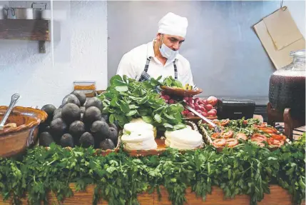  ?? Cristina Baussan, The Associated Press ?? A cook prepares lunch for guests at the El Hidalguens­e restaurant in Mexico City on Friday. Mexicans are dismayed by continued increases in the price of avocados, a staple of the country’s cuisine. Mexico’s government says increased demand in the United States and a slight drop in production are to blame. The price in the United States hit $2.23 per pound this week.