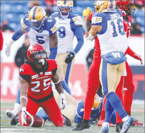  ?? — CP PHOTO ?? The Blue Bombers and Stampeders compete in last season’s Grey Cup. For 2021, the CFL’s non-player, football operations cap will drop to $2,070,400, a 20 per cent cut from the current $2,558,000.