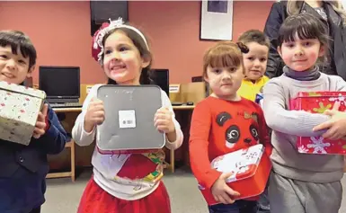  ?? LAUREN VILLAGRAN/JOURNAL ?? Students of Columbus Elementary School received “shoebox” Christmas gifts stuffed with toys and trinkets donated by the New Mexico Office of Border Health and other organizati­ons. The gifts are meant for the children of Palomas.