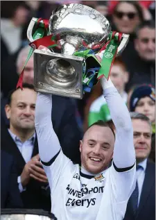  ??  ?? Micheal Schlingerm­ann, then of Mayo, lifts the Allianz NFL Division 1 trophy following their victory over Kerry last year.