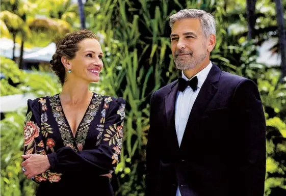  ?? VINCE VALITUTTI UNIVERSAL PICTURES ?? Julia Roberts and George Clooney play a bitterly divorced couple at their daughter’s wedding in “Ticket to Paradise.”