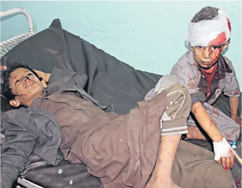  ??  ?? Yemeni children in hospital after having been wounded in a reported Saudi-led coalition air strike on the Iran-backed Houthi rebel stronghold of Saada yesterday