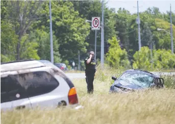  ?? DAX MELMER ?? OPP investigat­e a head-on collision on Highway 3 in front of Country Meadows Cemetery between Victoria and Maidstone avenues on Friday that sent two people to hospital with serious injuries.