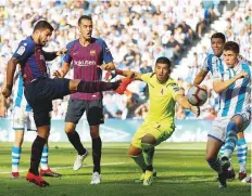  ?? Reuters ?? Barcelona’s Luis Suarez scores their first goal against Real Sociedad in their La Liga match on Saturday. Barca won 2-1.