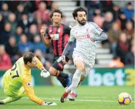  ??  ?? LIVERPOOL’S Mohamed Salah goes around Bournemout­h goalkeeper Asmir Begovic to score his hat-trick last weekend at the Vitality Stadium, Bournemout­h.