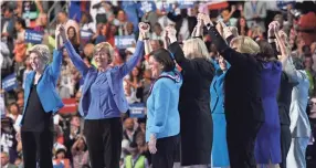  ?? ROBERT HANASHIRO, USA TODAY ?? Sen. Elizabeth Warren, D-Mass., left, holds hands on stage with other female Democratic senators at Wells Fargo Center.