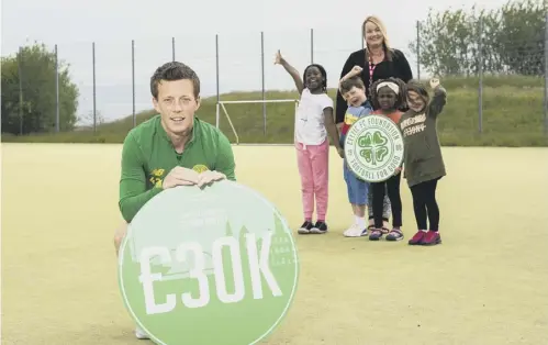  ??  ?? 0 Midfielder Callum Mcgregor, pictured yesterday with St Teresa’s Primary School head teacher Lesley Fee and children from local schools after Celtic made a £30,000 donation to 12 local schools and nurseries as part of their Football For Good Fund.