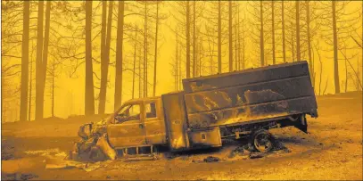  ?? Noah Berger The Associated Press ?? A scorched truck rests on Highway 168 on Tuesday after the Creek Fire burned through the area in Fresno County, Calif. California has already set a record with nearly 2.3 million acres burned this year.