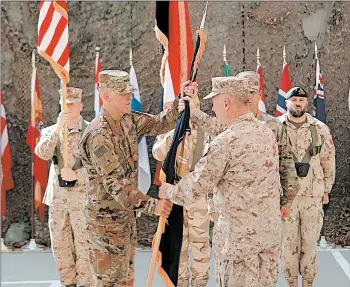  ?? KHALID MOHAMMED/AP 2019 ?? Army Lt. Gen. Pat White faces the daunting task of rebuilding trust at Ford Hood, which has one of the highest rates of murder, sexual assault and harassment in the Army. Above, White, foreground left, in a ceremony in Baghdad, Iraq.