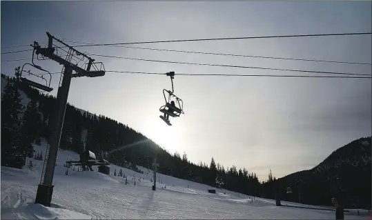  ?? (AP/Brittany Peterson) ?? Skiers ride a lift at Arapahoe Basin Ski Area on Jan. 19 in Dillon, Colo.