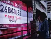  ?? Vincent Yu Associated Press ?? STOCK markets slid Tuesday after Trump tweeted that he’s “a Tariff Man.” Above, a Hong Kong bank.