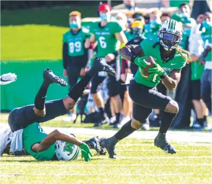  ?? SHOLTEN SINGER/THE HERALD-DISPATCH VIA AP ?? Marshall wide receiver Willie Johnson catches a tipped pass and turns upfield against Appalachia­n State during Saturday’s game in Huntington, W.Va. The host Thundering Herd beat the No. 23-ranked Mountainee­rs 17-7.