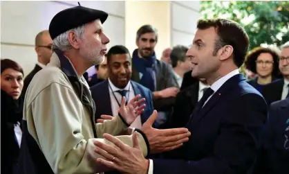  ?? Photograph: Reuters ?? French mathematic­s teacher Pierre Coste speaking with President Emmanuel Macron about pensions.