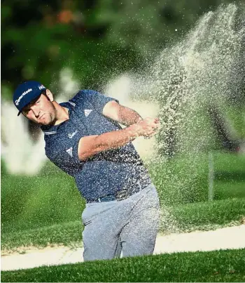  ?? — AFP ?? Focused: Jon Rahm hits a shot out of the fairway bunker during the first round of the CareerBuil­der Challenge at La Quinta Country Club on Thursday.