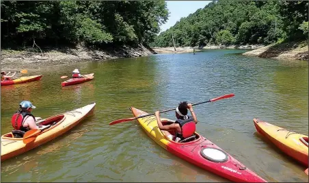  ?? NWA Democrat-Gazette/FLIP PUTTHOFF ?? Young kayak paddlers start their exploratio­n of Van Winkle Hollow on Beaver Lake at Hobbs State Park-Conservati­on Area. Much of the creek arm is undevelope­d and a favorite destinatio­n for paddlers.