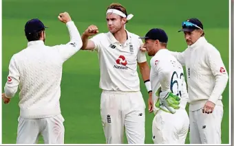  ??  ?? Given the elbow: Broad and his team-mates celebrate the removal of Brooks