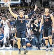  ?? [AP PHOTO] ?? Virginia’s Kyle Guy, left, and Jack Salt walk off the court in January following a victory against Duke in Durham, N.C. The Cavaliers remained at No. 1 in Monday’s AP Top 25 poll, earning 42 of 65 first-place votes.