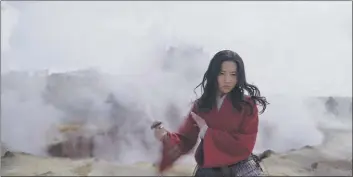  ??  ?? Mulan (Yifei Liu) rides into battle as Jun in “Mulan.”
Mulan (Yifei Liu) is gifted with a blade.