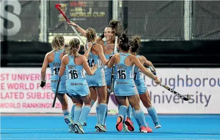  ?? GETTY IMAGES ?? Argentina players surround Noel Barrionuev­o after she converted a penalty stroke against the Black Sticks.