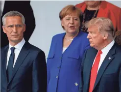  ?? GEOFFROY VAN DER HASSELT/AFP/GETTY IMAGES ?? NATO’s Jens Stoltenber­g, Germany’s Angela Merkel and President Donald Trump gather for the allies’ “family photo.”