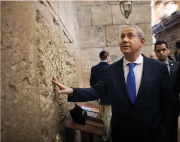  ??  ?? PRIME MINISTER Benjamin Netanyahu looks to heaven during a recent visit to the Western Wall.