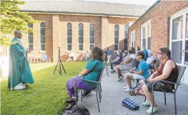  ?? RICK KINTZEL/ THE MORNING CALL ?? Father George Jose Kochuparam­bil stands before parishione­rs at an outdoor service Tuesday at Our Lady Help of Christians Church in Allentown.