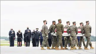  ?? Manuel Balce Ceneta / Associated Press ?? President Joe Biden, first lady Jill Biden, Secretary of Defense Lloyd Austin and Chairman of the Joint Chiefs of Staff Gen. Mark Milley watch as a Marine Corps carry team moves a transfer case containing the remains of Marine Corps Lance Cpl. David Espinoza, 20, of Rio Bravo, Texas on Sunday at Dover Air Force Base, Del. Biden embarked on a solemn journey Sunday to honor and mourn the 13 U.S. troops killed in the suicide attack near the Kabul airport as their remains return to U.S. soil from Afghanista­n.