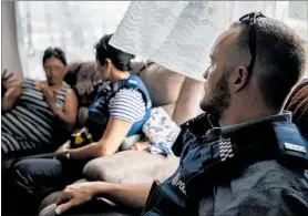  ?? PICTURE / NZ HERALD ?? A former meth dealer and recovering addict, talking with constables Karen Edwards and Nathaniel Blair, who accepted the police offer of referral for treatment rather than prosecutio­n.