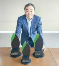  ?? ?? SM Investment­s president and CEO Frederic DyBuncio displays some of the trophies for SM’s 20 wins in the recently held Philippine Quill Awards.