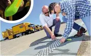  ??  ?? ON THE LINE WJ Group’s Wayne Johnston shows us truck that can paint grippy lines on road and place studs in roadworks; operators simply feed the machine