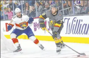  ?? Chase Stevens Las Vegas Review-Journal @csstevensp­hoto ?? The Knights’ Gage Quinney, playing in his first NHL game, sends the puck past the Panthers’ Aaron Ekblad during the first period at T-Mobile Arena.