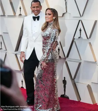  ??  ?? Alex Rodriguez with Jennifer Lopez in Tom Ford at the 2019 Oscars.