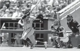  ?? JOHN PETERSON AP ?? Texas A&M outfielder Dylan Rock hits a two-run double in the third inning against Notre Dame during the Aggies’ 5-1 victory on Tuesday in Omaha, Neb.