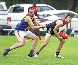  ?? ?? Moe’s Shaun Curtis grabs a hold of Warragul’s Toby Murfet’s guernsey as he tries to tackle him in the reserves.