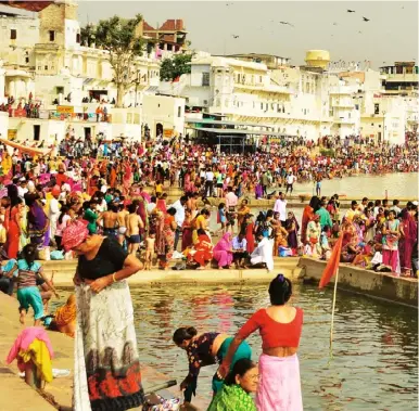  ??  ?? Above Pushkar lake during the maha snan (big bath), in honour of Lord Brahma, who supposedly
created the lake. Below Pushkar camel fair