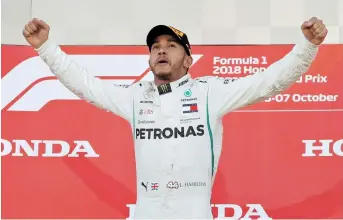  ??  ?? Mercedes’ Lewis Hamilton yesterday celebrates winning the Japanese Grand Prix at Suzuka Circuit, Suzuka, Japan. — Reuters