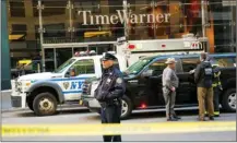  ?? The Associated Press ?? A police officer keeps watch in front of the Time Warner Building in New York, where an explosive device was removed Wednesday.